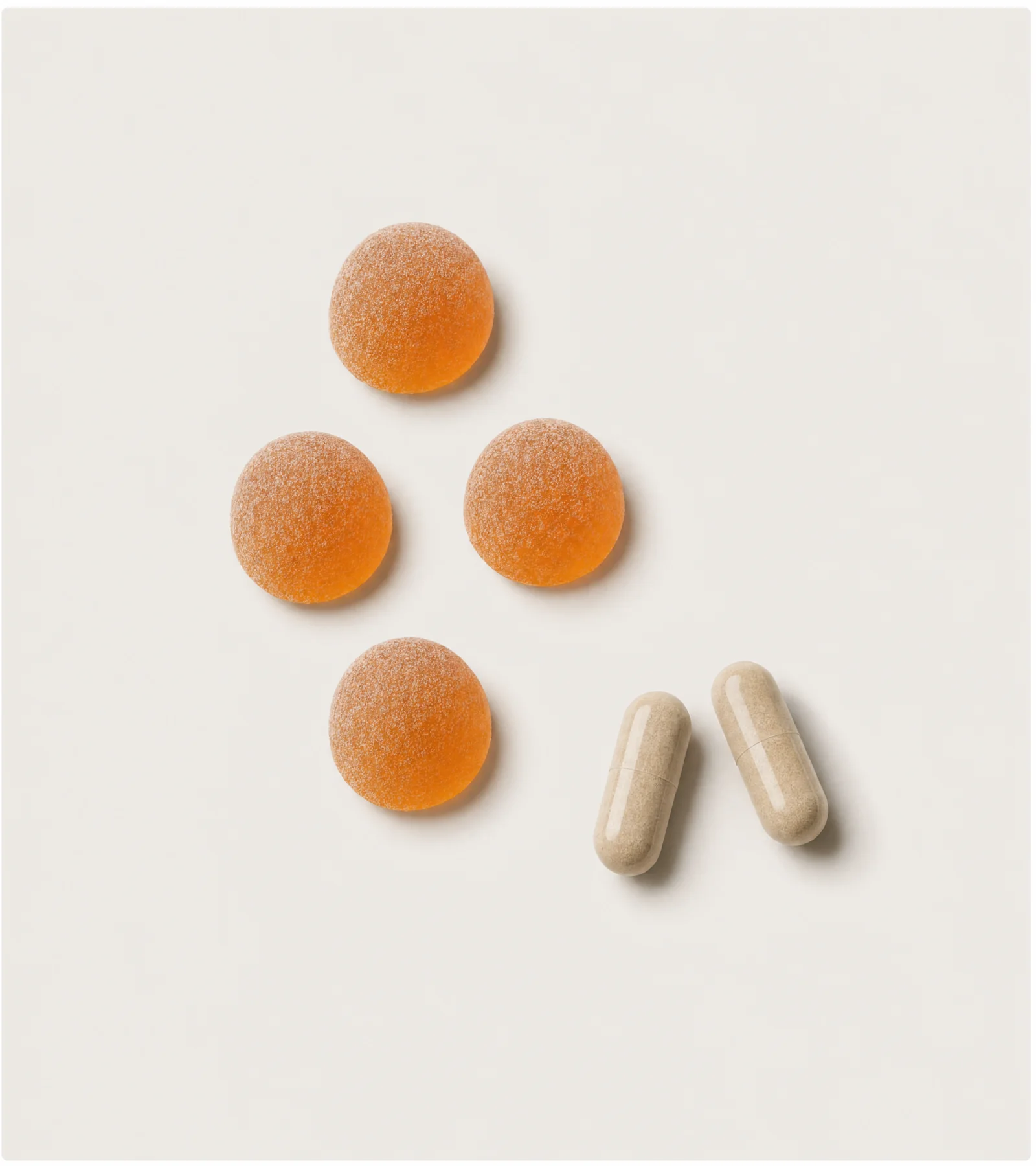 Gummies and capsules on cream background
