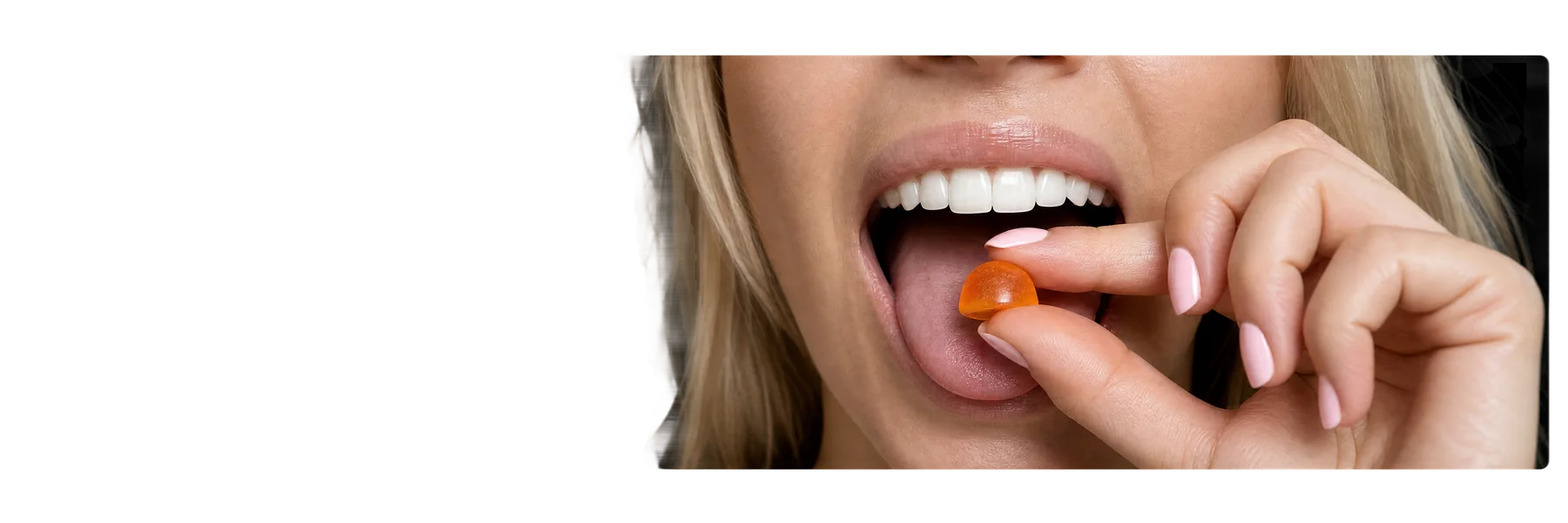 Woman taking orange gummy