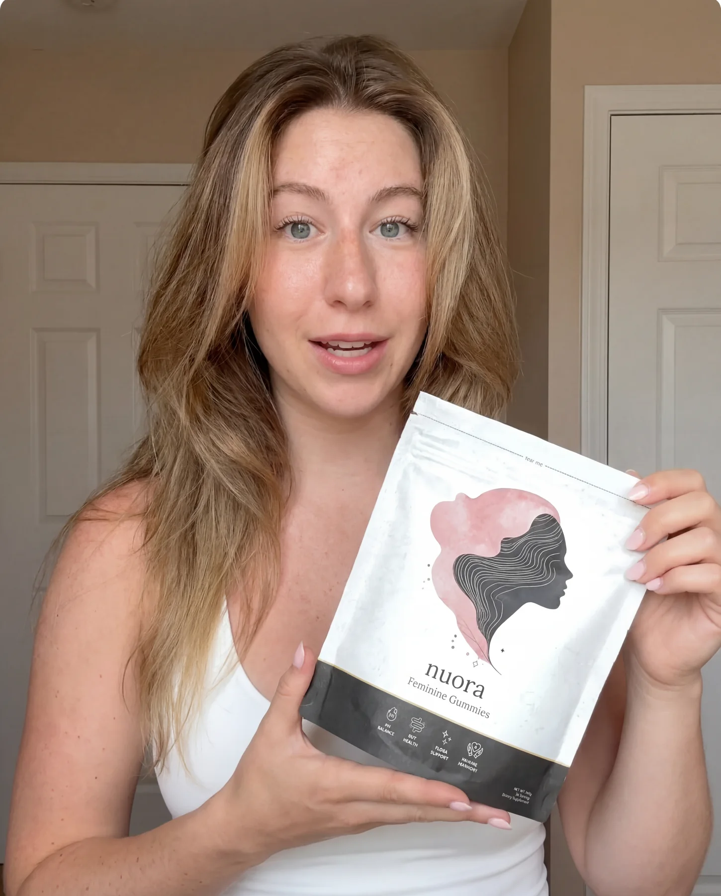 Verified buyer holding Nuora pouch